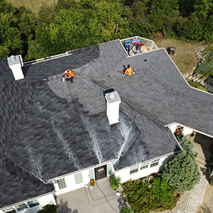 Photo of roof restoration service. done by roof rescue, wnc roofers. large family house in nature